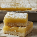 Easy lemon bars with shortbread crust and powdered sugar in a 9x13 pan