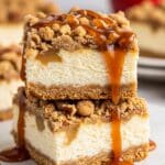 Layering caramel apple cheesecake bars with crust, cheesecake, apple topping, and crumble.