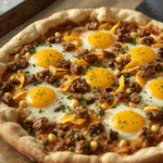 Blackstone‑style Cheese Crust Breakfast Pizza with sunny eggs