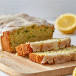 Close-up lemon zucchini bread slice showing tender crumb and thin lemon glaze​