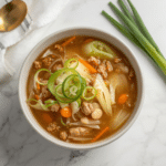 Alt Text: One-pot Cabbage Egg Roll Soup with gluten free chicken and green cabbage, emphasizing its status as a quick weeknight dinner.