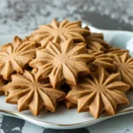 Stack of holiday cookies on a festive plate, demonstrating a coffee butter cookies recipe ideal for Christmas baking and sweet gift ideas.