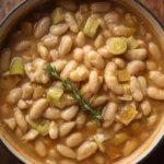 Sizzling Creamy Butter Beans with Leeks in a pan.