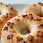Sliced Garlic Parmesan Cottage Cheese Bagels served with cream cheese, reflecting Breakfast Ideas With Cottage Cheese.