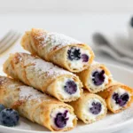 A stack of four keto blueberry cream cheese roll-ups.