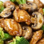 Chicken Broccoli Mushroom Stir-Fry : Easy Chicken Stir Fry served over a bed of steaming white jasmine rice in a white bowl.
