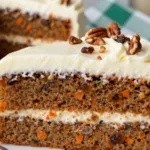 A stunning 3 layer carrot cake with smooth cream cheese frosting and decorative swirls, perfect for a carrot birthday cake.