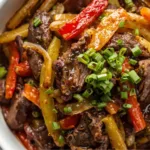 Healthy Asian beef and onion stir fry with green onions