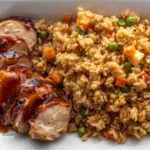 Glass meal prep containers neatly packed with portions of homemade teriyaki chicken fried rice and fresh steamed broccoli on the side.